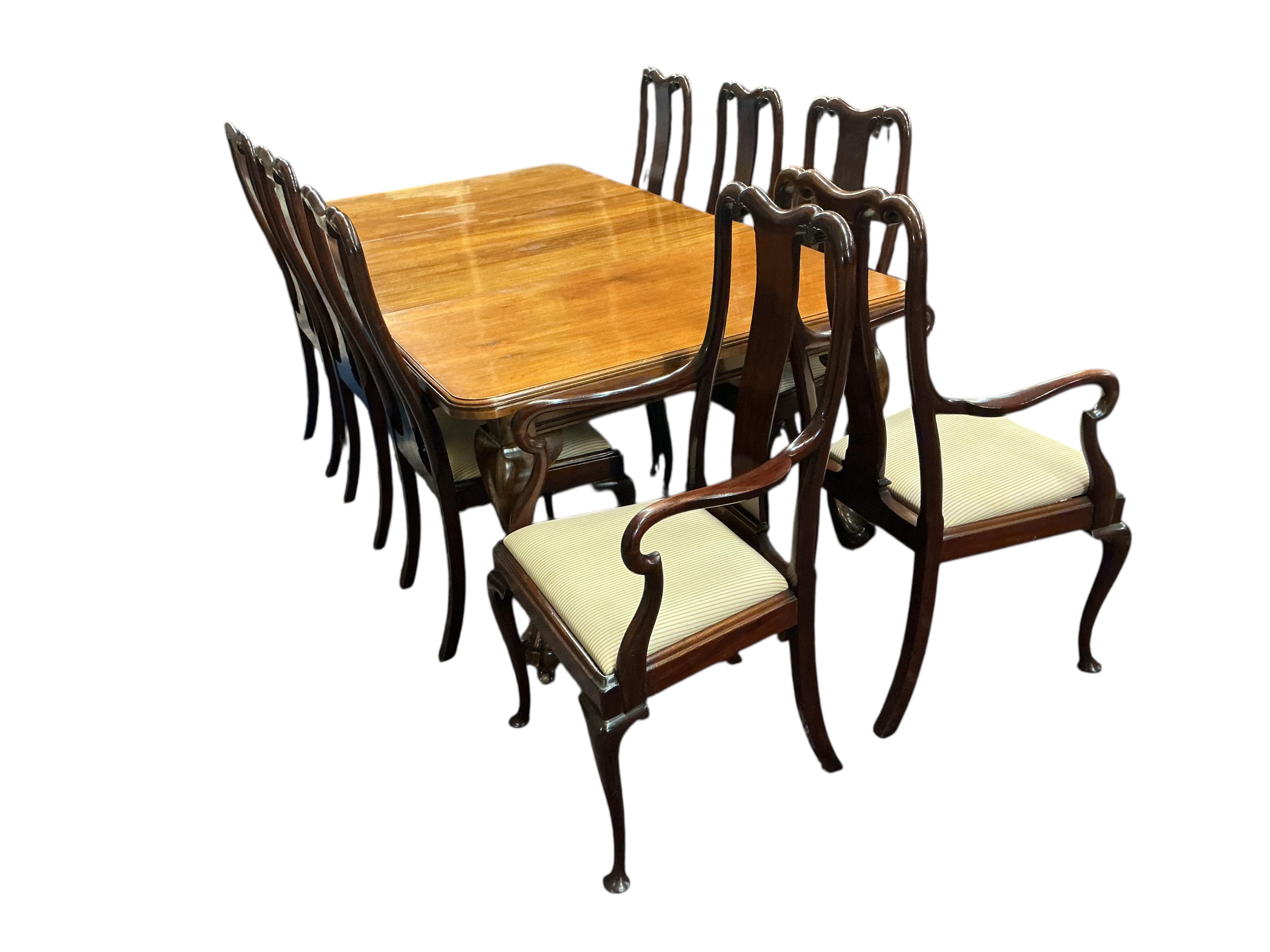 A 1920's mahogany extending dining table 206cm extended, one spare leaf, and eight Queen Anne style mahogany dining chairs, two with arms